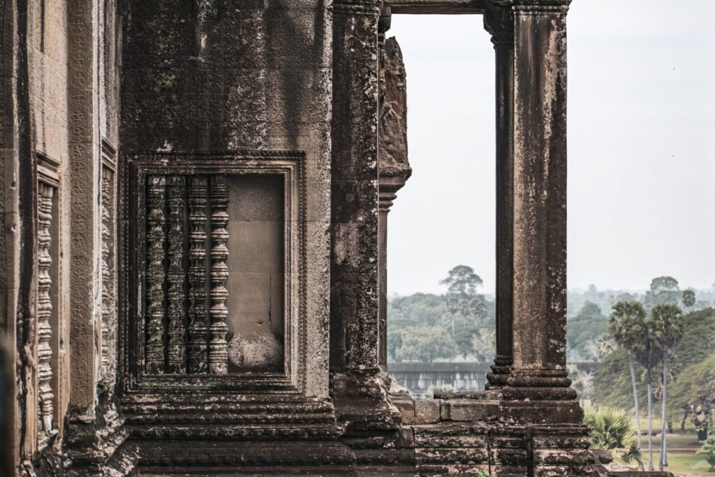 Stunning view of Angkor Wat temple pillars showcasing ancient Khmer architecture in Siem Reap, Cambodia.